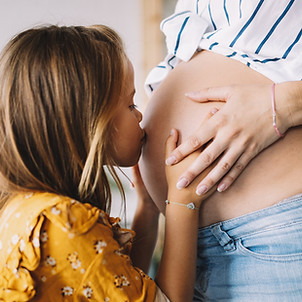 Daughter Kissing Pregnant Mom
