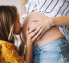 Daughter Kissing Pregnant Mom