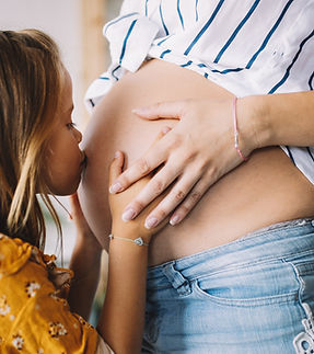 Daughter Kissing Pregnant Mom