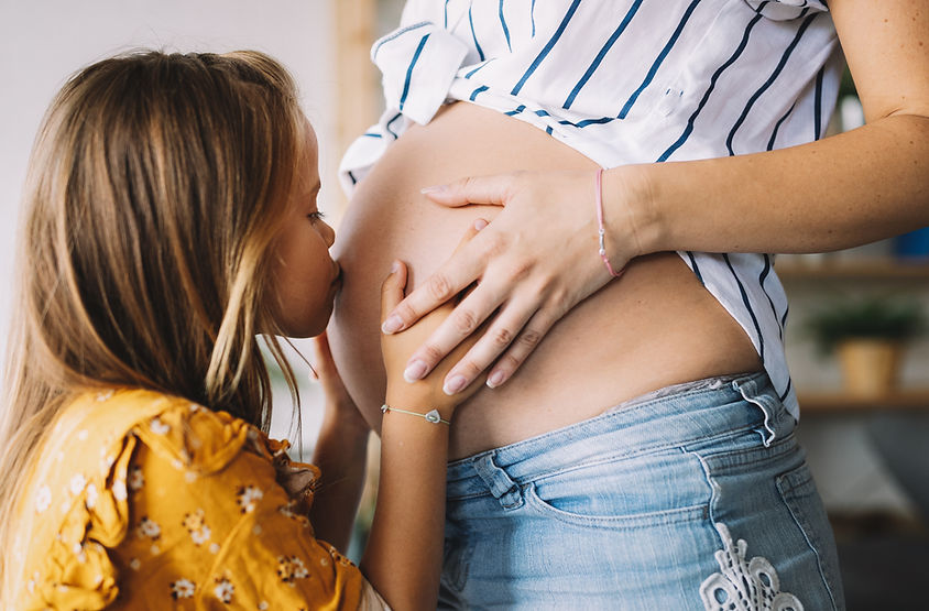Daughter Kissing Pregnant Mom