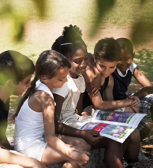Kids Reading Book in Park
