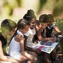 Kids Reading Book in Park