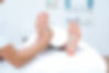 Physiotherapist doing foot massage in medical office