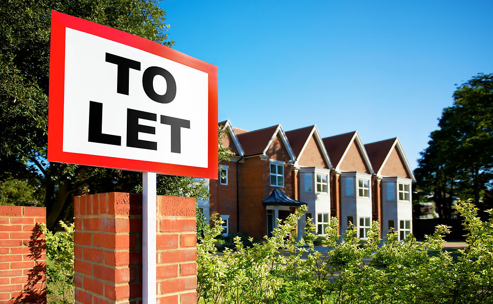 Red and white To Let sign standing in front of a row of modern brick semi-detached houses