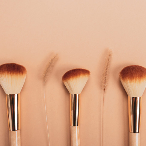 makeup brushes sitting on table ready for a maternity photoshoot