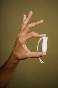 Hand Holding Tampon