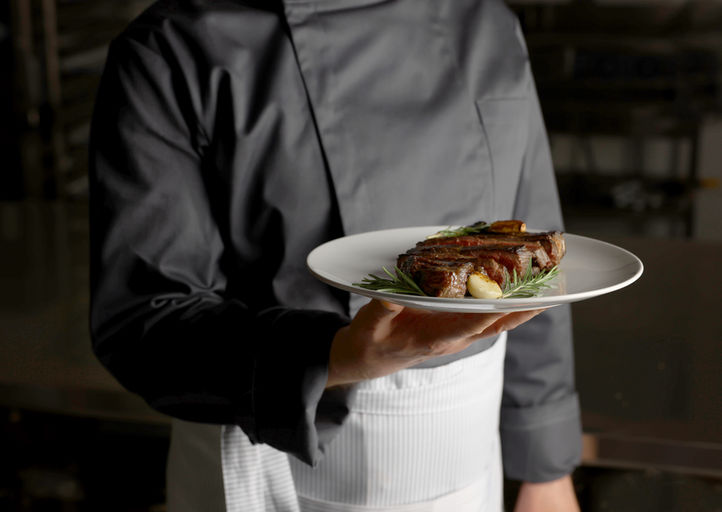 Chef holding plate of food