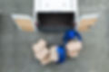 Above shot of delivery men unloading cardboard boxes from a truck on the street