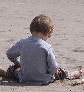 Child Sitting Outdoors