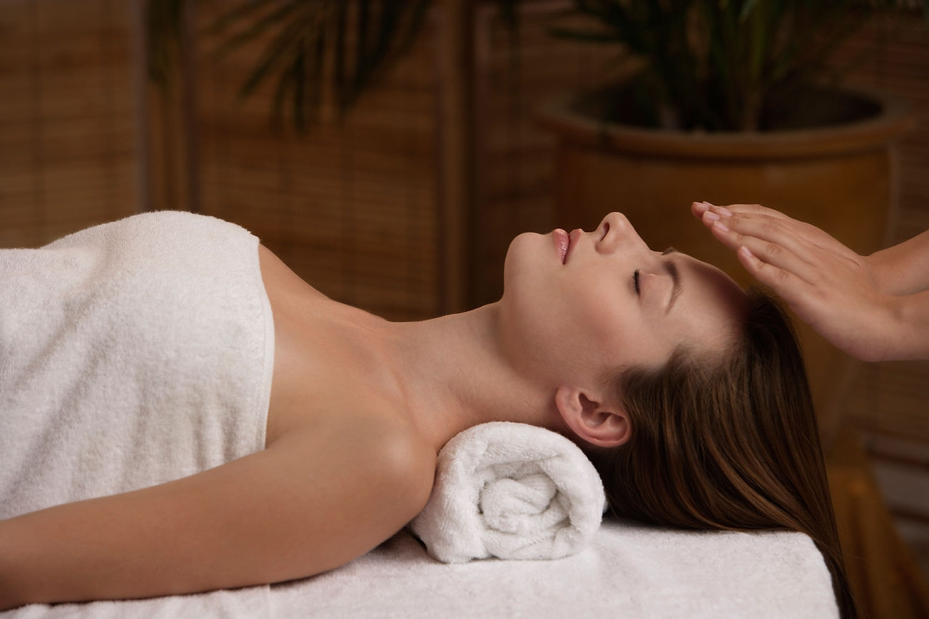Young woman receiving reiki massage