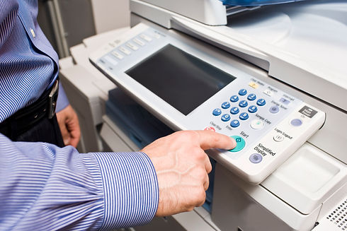 Business man with his finger on the start key and ready to make a photocopy