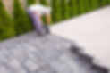 worker is laying paving stones.
