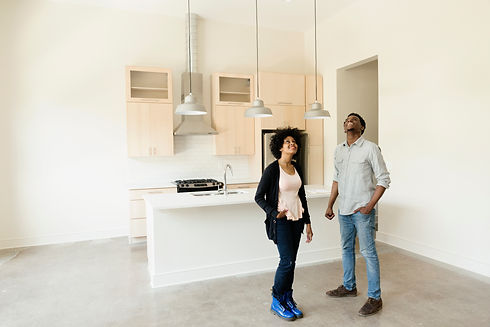 Couple standing in kitchen in new house