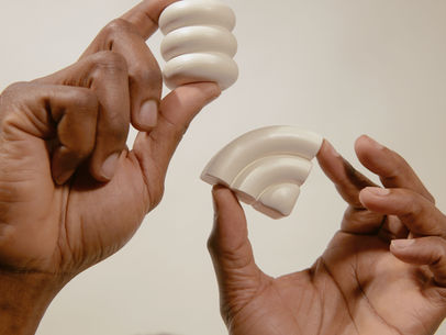 Two hands holding puzzle-like shapes that almost fit together, symbolizing couples conflict and connection.