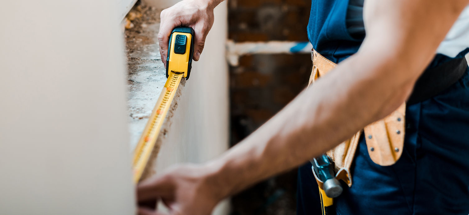 man measuring for a home repair