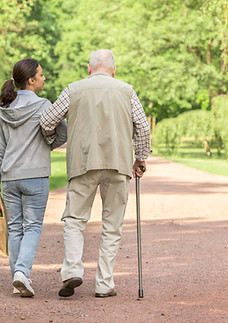 Woman helping an elderly man with shopping