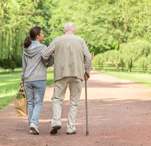Woman helping an elderly man with shopping