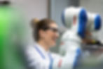 Engineer working with robotic system to support automation, precision, and advanced engineering processes
