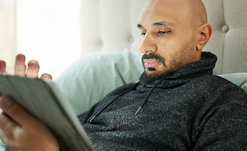 Man Reading Tablet