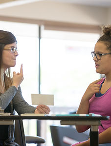 Speech therapy session working one-on-one with a high school student to enhance articulation and communication skills.