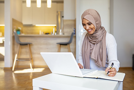 A muslim woman completing an online workshop from home
