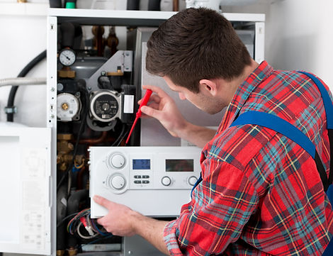 Technician servicing the gas boiler for hot water and heating
