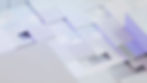A close-up view of a grid-like pattern composed of variously sized, white, square tiles.