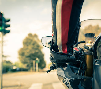 Motorcyclist on the road - Racing motorbike stops at traffic lights
