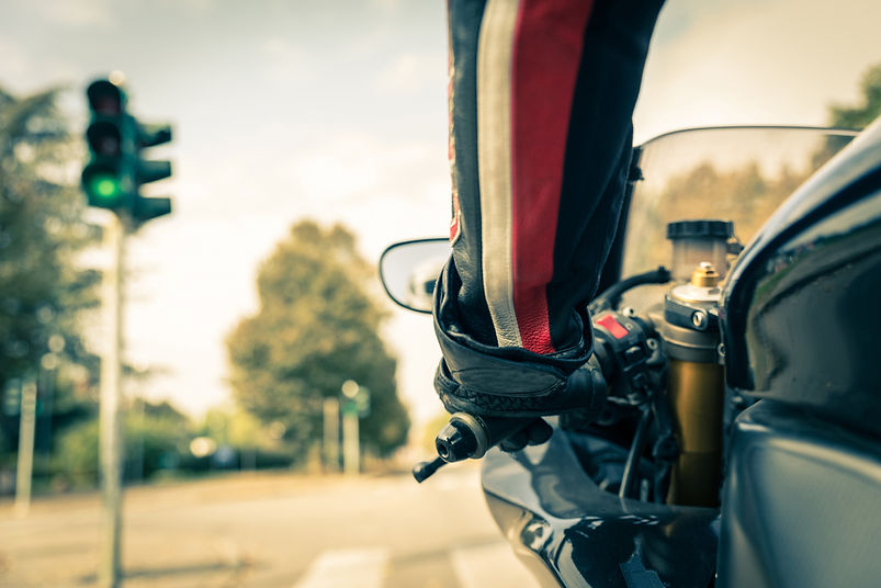 Motorcyclist on the road - Racing motorbike stops at traffic lights
