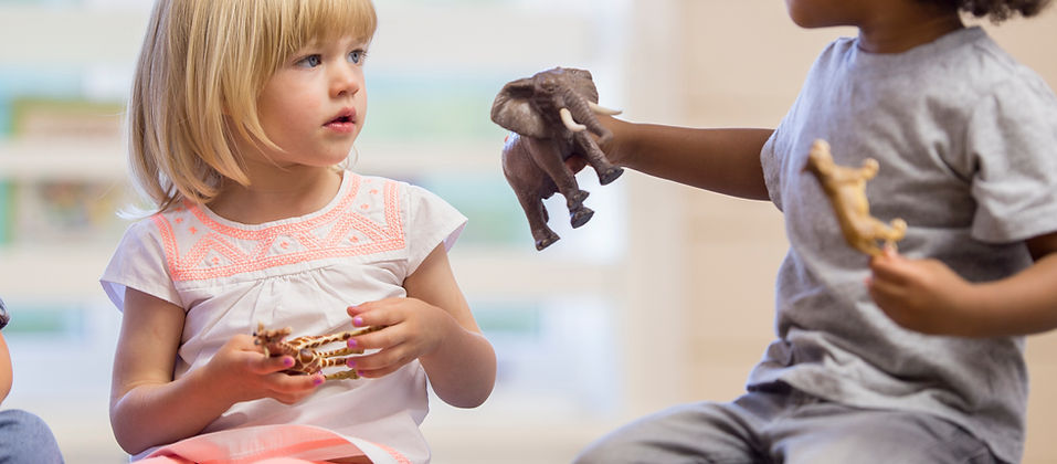 Children playing with toy animals
