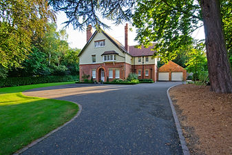 View of a country house with an asphalt driveway