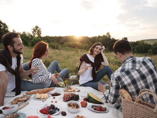 Relationships between friends and loved ones depicted in a picnic scene