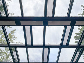 Underside view of a bespoke steel frame glass roof canopy