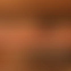 A kitchen with red tile and wooden cabinets.