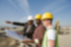 Surveyor and construction workers on site