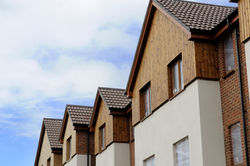 Looking up and down a length of unfinished top floor apartments on a building site