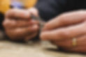 Close-up of a jeweler mounting a gemstone onto a ring