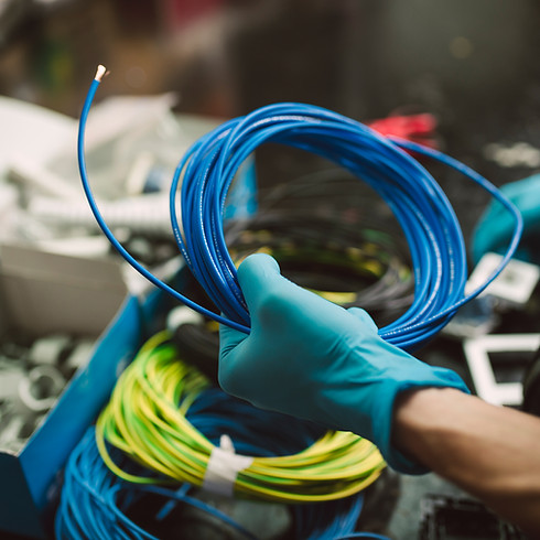 Man holding a roll of electric cable, Spain