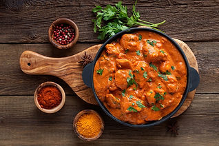Traditional chicken tikka masala curry in a black serving dish