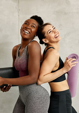 Women holding Pilates mats