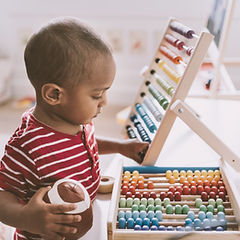 Boy Playing with Abacus