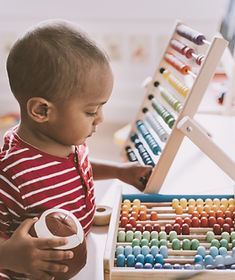 Boy Playing with Abacus