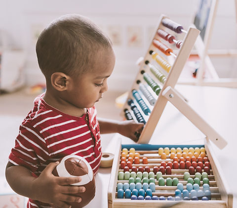 Boy Playing with Abacus