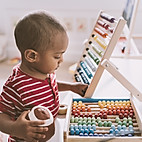 Boy Playing with Abacus