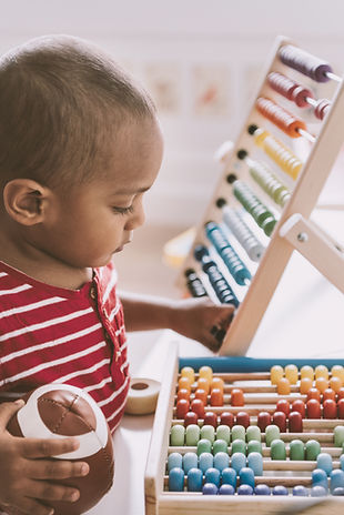 Boy Playing with Abacus