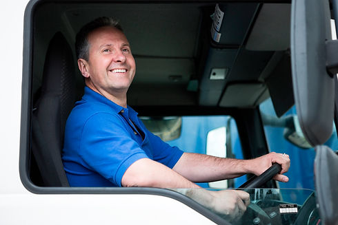 Smiling man sitting in a truck driver's seat