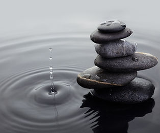Water drops near a stack of stones