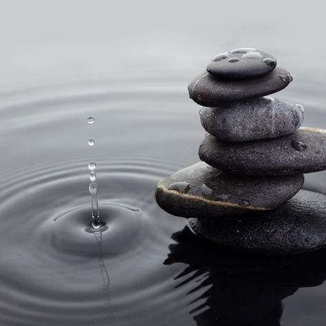 Water drop near a stack of stones