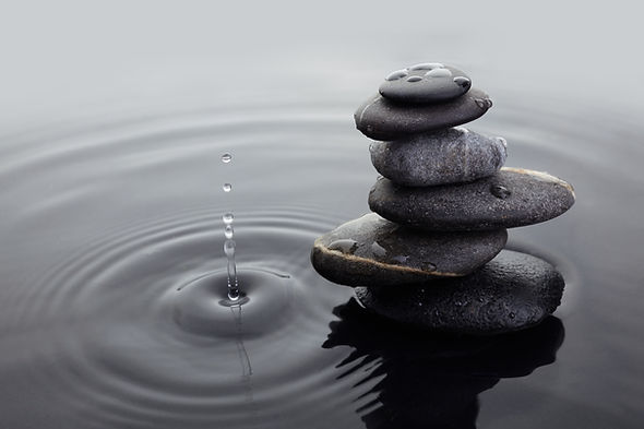 Water drops near a stack of stones