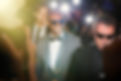 Smiling celebrity in sunglasses being photographed by paparazzi photographers at event
